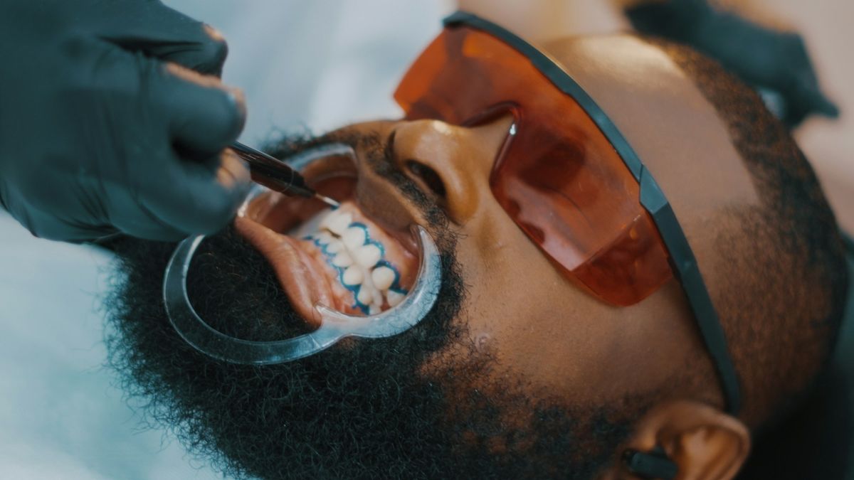 Dentist cleaning a patient's teeth (illustrative stock photo)